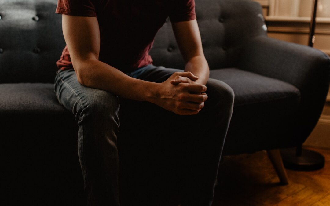 man sitting on sofa